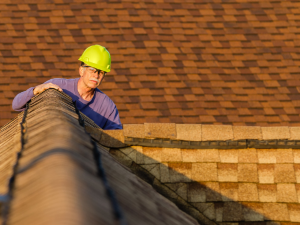 A Carlsbad roofer inspecting a roof