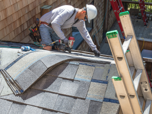 Asphalt shingles being expertly installed by San Diego roofing contractors, showcasing durability.