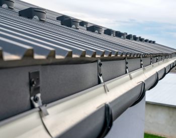 Clean gutters and downspouts to help prevent roof and foundation damage in El Cajon